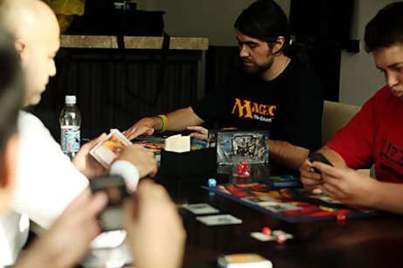 Olivier Gheysen, centre, plays Magic: The Gathering with other Wizards of the Gulf Coast.