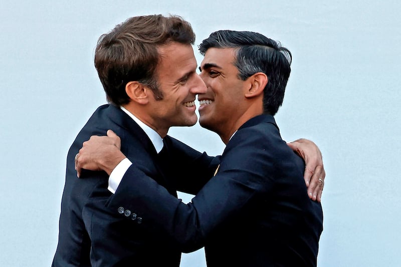 British Prime Minister Rishi Sunak, right, hugs French President Emmanuel Macron during a meeting at Cop27. AP