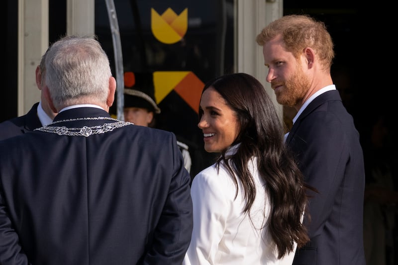 Prince Harry and Meghan, Duke and Duchess of Sussex, talk to mayor Jan van Zanen of The Hague, ahead of the Invictus Games, which take place from April 16 to 22. AP