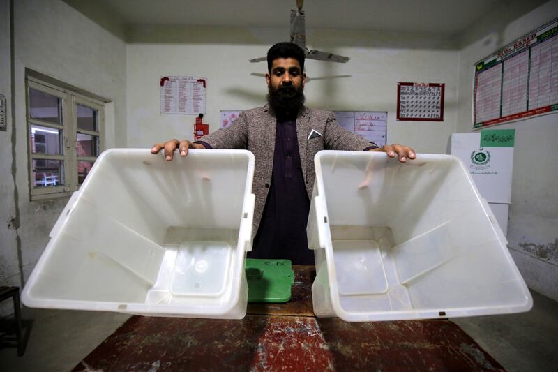 A polling officer sets up a polling station in Peshawar on the eve of the general election. EPA