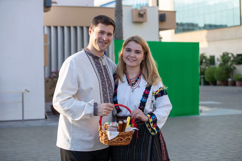 Liliia Datsyna and Andrii Opanashchuk with their basket of food blessed by a priest