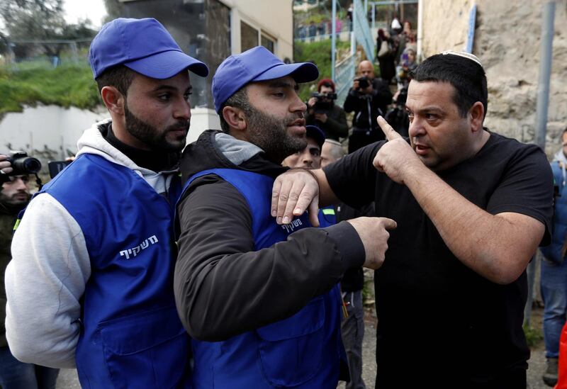epa07357775 An Israeli settler (R) argues with Palestinians wearing blue vests marking them as 'Observers' during a protest against the end of the mandate for the civilian Temporary International Presence in Hebron (TIPH) in the West Bank city of Hebron, 10 February 2019. The protest was aimed at marking the removal of the international observers mission from Hebron and anniversary of the so-called Cave of the Patriarchs massacre by Israeli settler Baruch Goldstein on 25 February 1994, that initially led to the establishing of the TIPH.  EPA/ABED AL HASHLAMOUN
