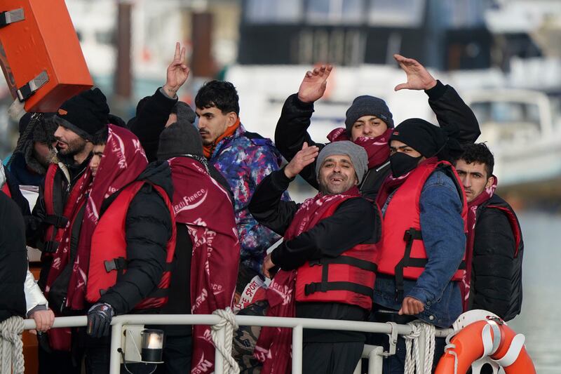 A group of migrants are brought in to Dover, Kent, by a lifeboat from the Channel. PA