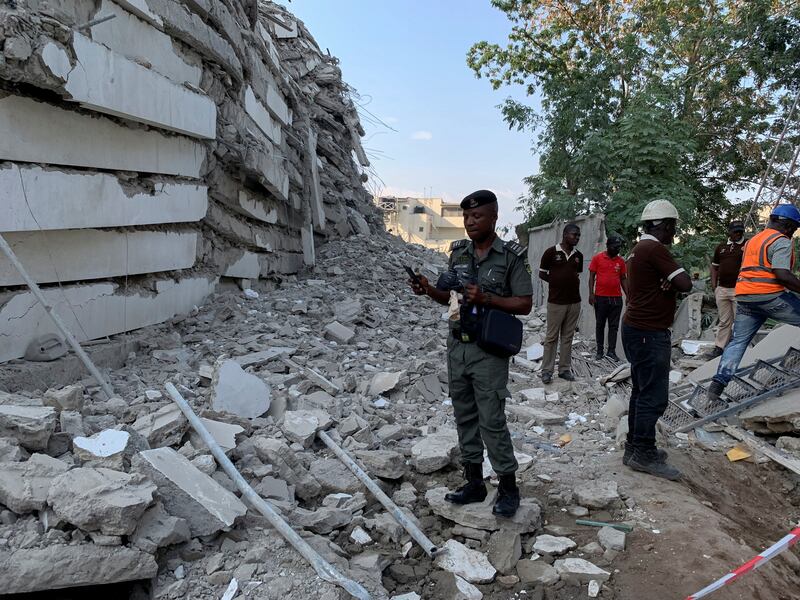 A policeman stands by the debris of the collapsed building in Ikoyi, Lagos.  Reuters