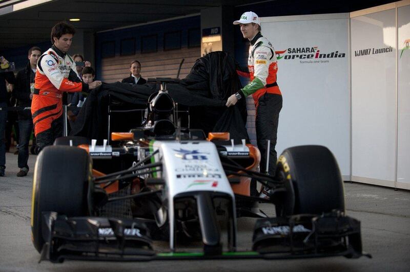 Force India drivers Sergio Perez (L) and Nico Hulkenberg unveil the Sahara Force India VJM07 racing car for the 2014 Formula One season on Tuesday. Jorge Guerrero / AFP  

