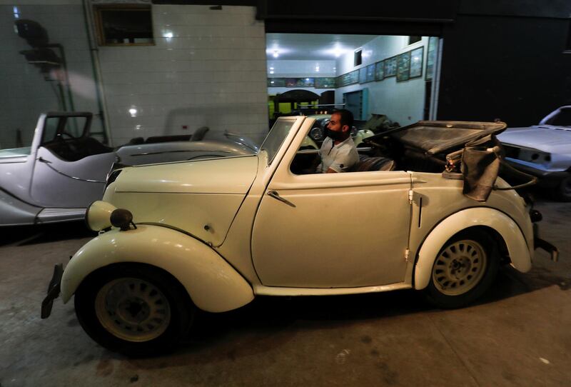 Aymandrives a British Standard Flying Eight Tourer - 1948 automobile at his father's store. Reuters