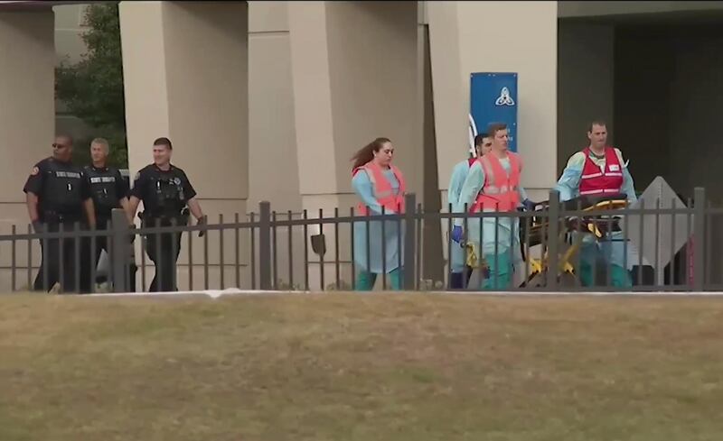 This photo taken from video provided by WEAR-TV shows emergency responders near the Naval Air Base Station in Pensacola, Fla., Friday, Dec. 6, 2019.  The US Navy is confirming that an active shooter and one other person are dead after gunfire at the Naval Air Station in Pensacola. Area hospital representatives tell The Associated Press that at least 11 people were hospitalized. The base remains locked down amid a huge law enforcement response.Â   (WEAR-TV via AP)