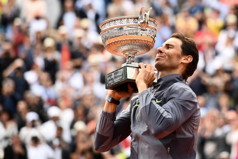 Spain's Rafael Nadal poses with the Mousquetaires Cup (The Musketeers) at the end of the men's singles final match against Austria's Dominic Thiem on day fifteen of The Roland Garros 2019 French Open tennis tournament in Paris on June 9, 2019.  / AFP / Martin BUREAU
