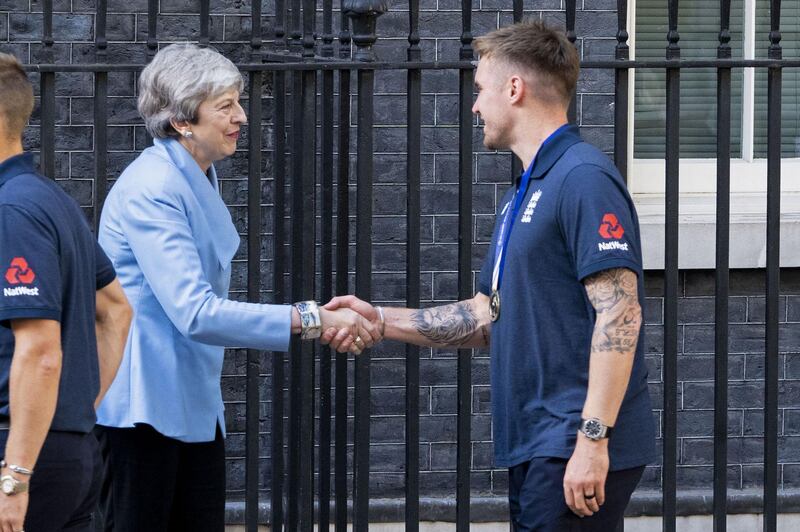 British prime minister Theresa May shakes hands with England opener Jason Roy. AFP