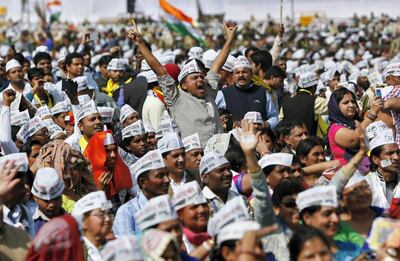 A supporter of Aam Aadmi (Common Man) Party (AAP) cheers after its chief Arvind Kejriwal took an oath as the new chief minister of Delhi during a swearing-in ceremony at Ramlila ground in New Delhi February 14, 2015. The two-year-old anti-graft party took office in the Indian capital on Saturday, promising to fight divisive politics in a challenge to the federal government of Narendra Modi that has faced criticism for attacks on churches and other minorities. REUTERS/Anindito Mukherjee (INDIA - Tags: POLITICS)