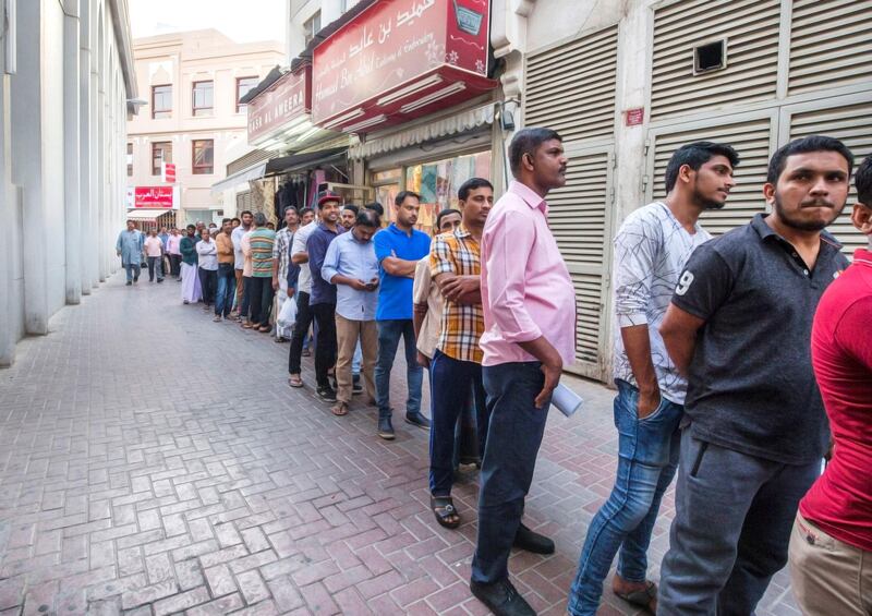 DUBAI,  UNITED ARAB EMIRATES, 20 May 2018 - People queueing to get  take away porridge for the iftar at Lootah Masjid Mosque, Deira, Dubai. Leslie Pableo for The National  for Ramola Talwar story