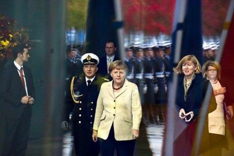 The German chancellor Angela Merkel, centre, opposed the $70 billion merger between BAE Systems and EADS. John Macdougall / AFP
