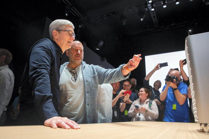 Apple CEO Tim Cook (left) and Apple's Chief Design Officer Jonathan Ive look over the new Mac Pro Display and computer during Apple's Worldwide Developer Conference (WWDC) in San Jose, California on June 3, 2019. (Photo by Brittany Hosea-Small / AFP)