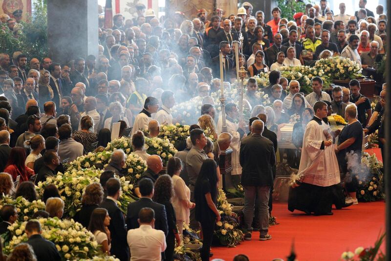Incense is spread during a funeral service for some of the victims of a collapsed highway bridge, in Genoa's exhibition center Fiera di Genova, Italy. AP