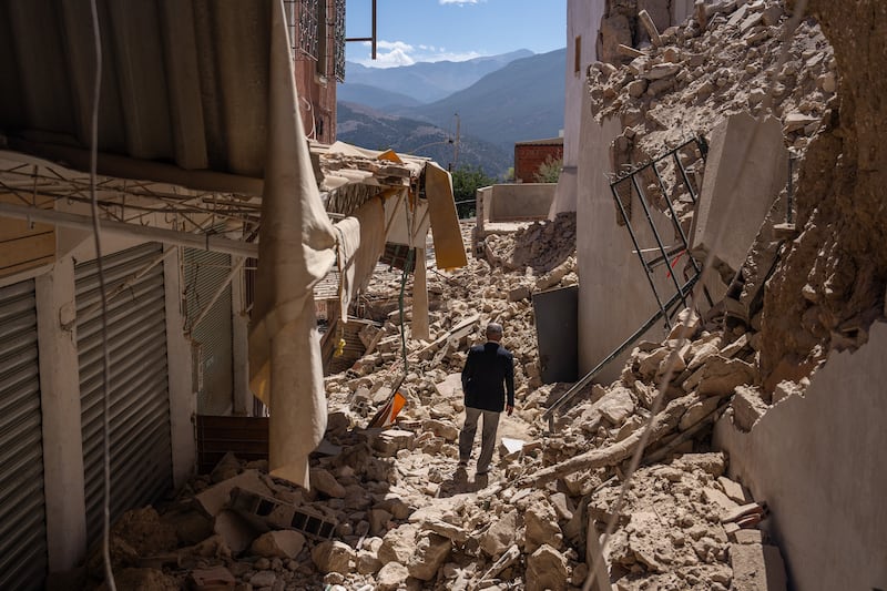 A man walks amongst the rubble of collapsed buildings following yesterday's earthquake, in Moulay Brahim, Morocco. Getty Images
