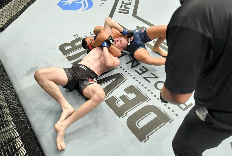 ABU DHABI, UNITED ARAB EMIRATES - JULY 12: (R-L) Makwan Amirkhani of Finland secures an anaconda choke submission against Danny Henry of Scotland in their featherweight fight during the UFC 251 event at Flash Forum on UFC Fight Island on July 12, 2020 on Yas Island, Abu Dhabi, United Arab Emirates. (Photo by Jeff Bottari/Zuffa LLC)