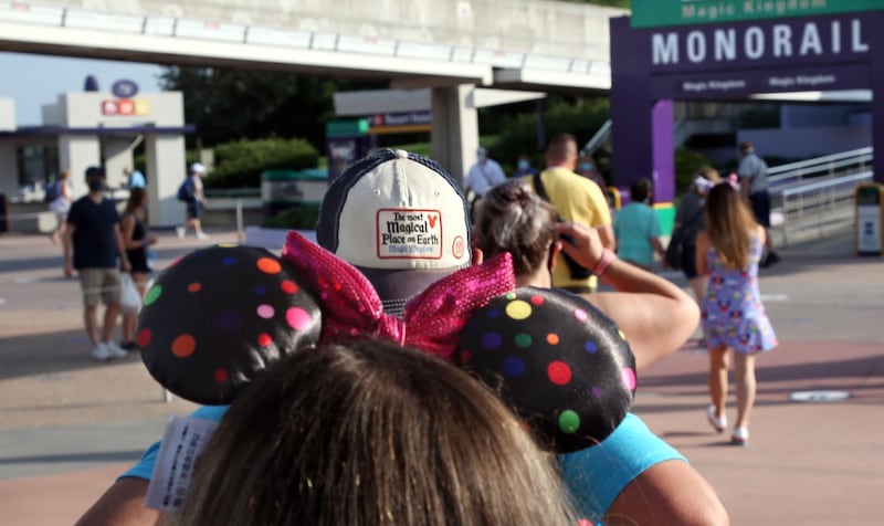 Guests arrive at the transportation center at the Magic Kingdom theme park at Walt Disney World on the first day of reopening, in Orlando, Florida, on July 11, 2020. AFP