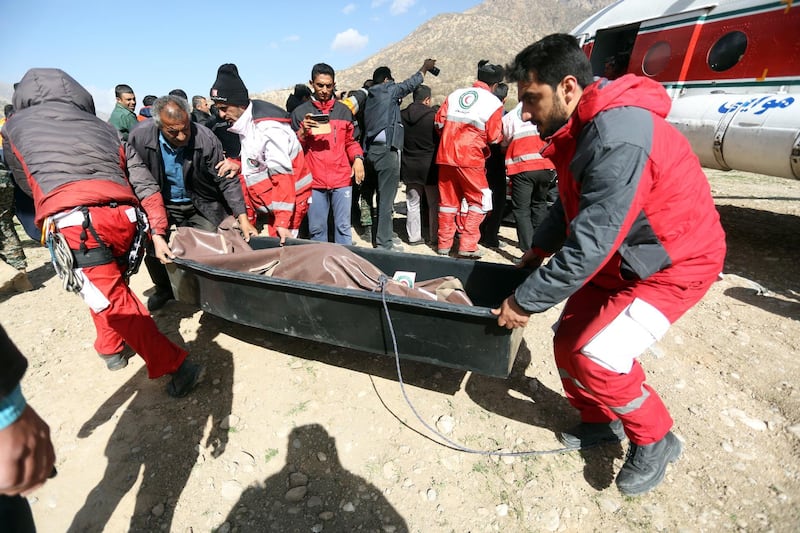 Members of the Iranian Red Crescent carry a body recovered from a wreckage of the private jet in the mountains around the city of Shahr-e Kord, Iran. Morteza Salehi / EPA