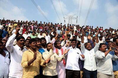 People shout slogans in favor of police and cheer them while gathering near the place where rape accused were shot in Shadnagar some 50 kilometers or 31 miles from  Hyderabad, India, Friday, Dec. 6, 2019. An Indian police official says four men accused of raping and killing a woman in southern India have been fatally shot by police. (AP Photo/Mahesh Kumar A.)