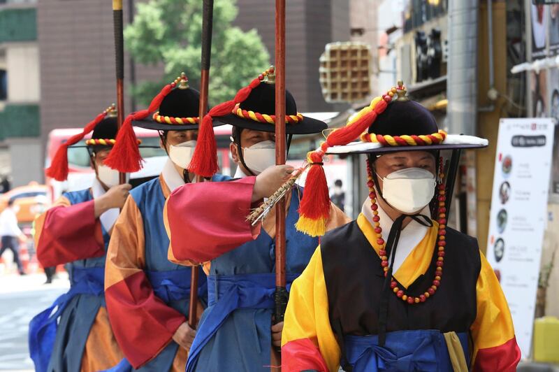 South Korean imperial guards wear face masks as they patrol near the Deoksu Palace in Seoul. AP Photo