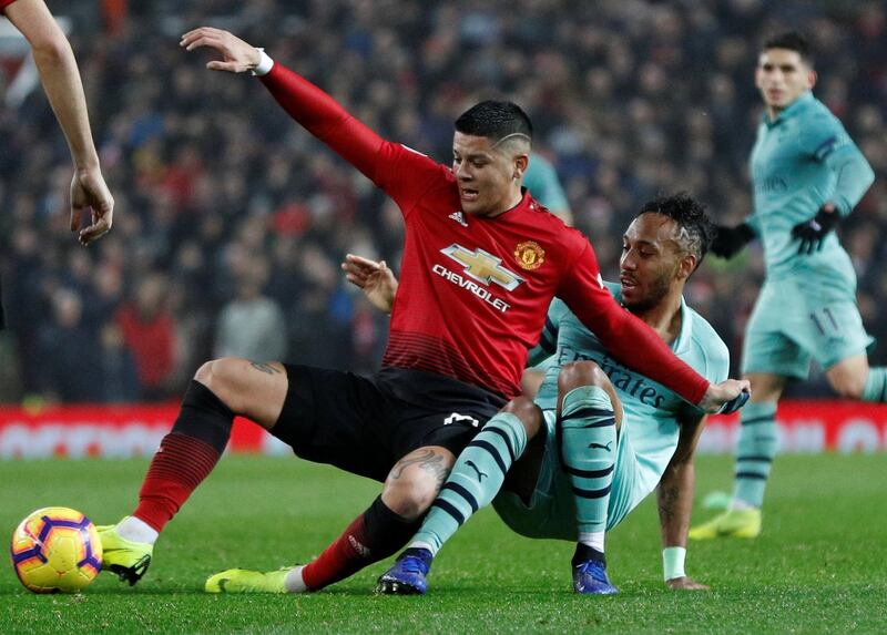 Manchester United's Marcos Rojo in action with Arsenal's Pierre-Emerick Aubameyang. Reuters