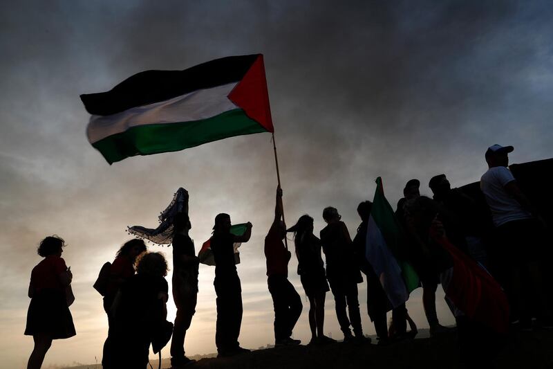 Israeli activists protest in solidarity with Palestinians during the Friday protest at the Israeli Gaza border near Nahal Oz, facing the Gaza Neighborhood of Shajaiya.  Israeli army deployed more soldiers along the border. EPA