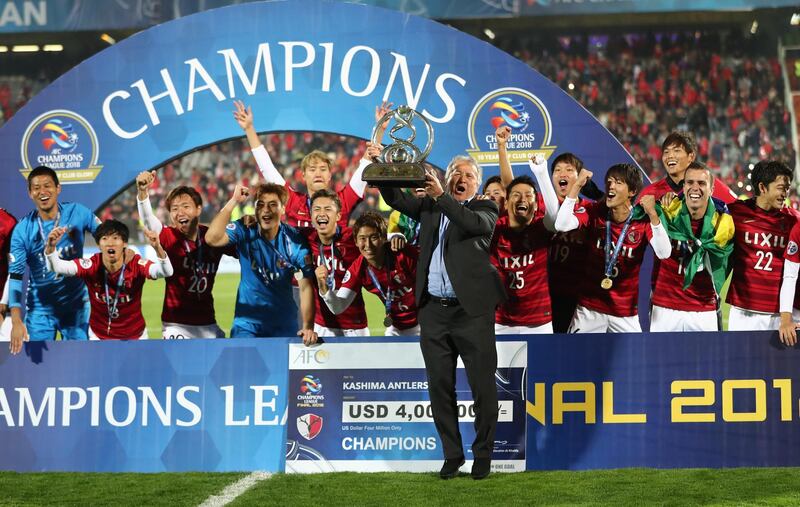Former Kashima Antlers player and manager Zico and  Kashima Antlers players celebrate with the Asian Champions League trophy. Getty Images