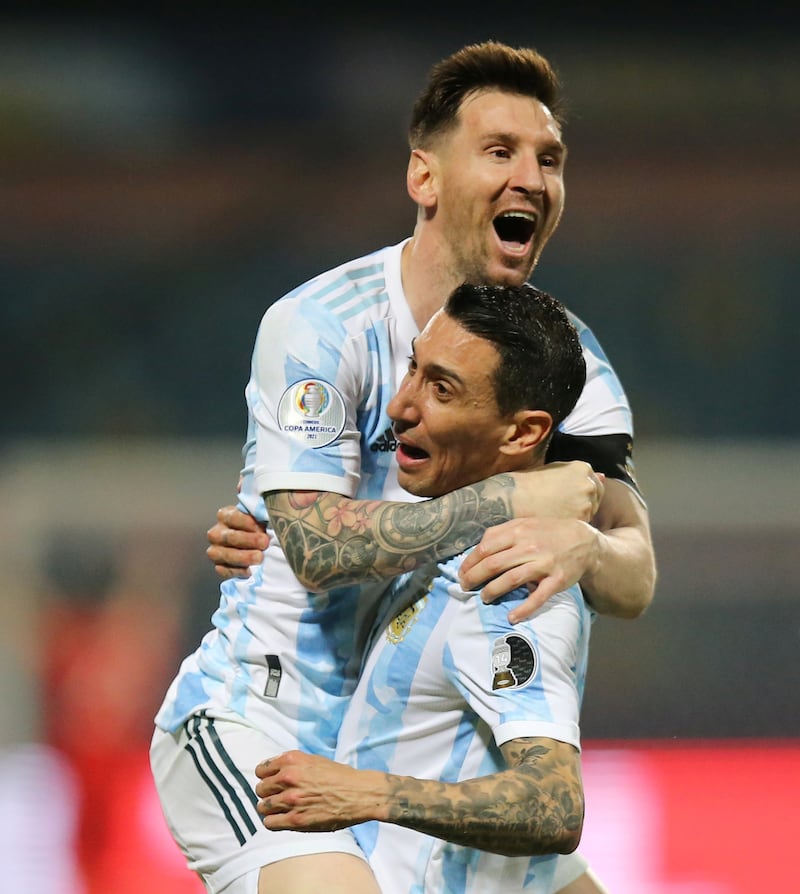 Argentina's Lionel Messi celebrates scoring their third goal against Ecuador with Angel Di Maria. Reuters