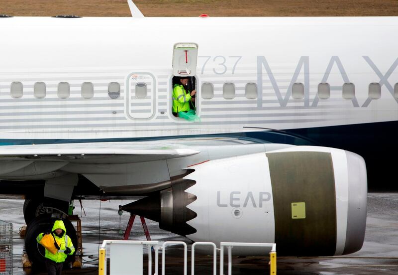 (FILES) In this file photo taken on March 12, 2019, workers are pictured next to a Boeing 737 MAX 9 airplane on the tarmac at the Boeing Renton Factory in Renton, Washington.  A fix to the anti-stall system suspected in October's Lion Air Boeing 737 MAX 8 that killed 189 people in Indonesia is ready to roll out, industry sources told AFP on March 23, 2019. Boeing was due to present the patch to officials and pilots of US airlines American, SouthWest and United in Renton, Washington state, where the craft is assembled, the sources said. This upgrade has yet to be approved by the Federal Aviation Agency, one of the authorities that grounded the 737 MAX after two deadly crashes in five months. - 
 / AFP / Jason Redmond
