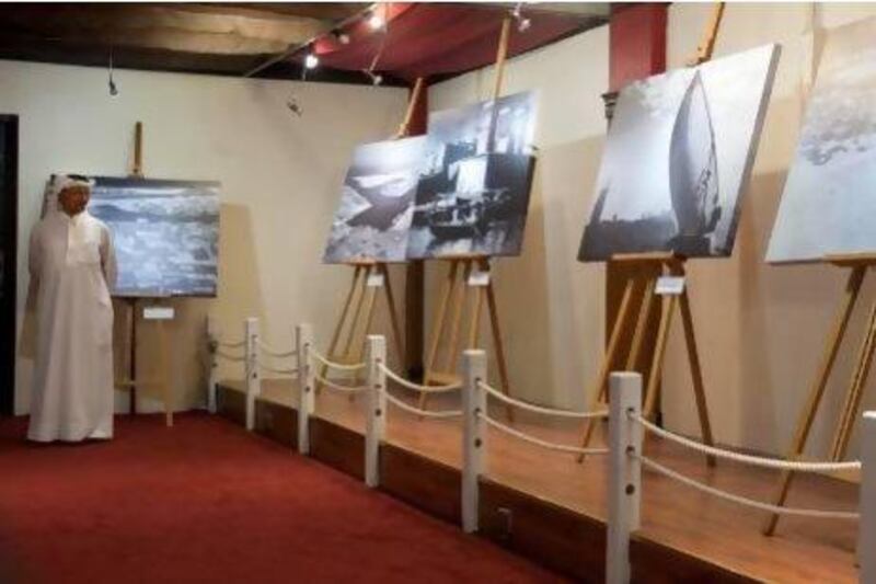 The two-week exhibition showcases sepia-tinted photographs of an age when pearl divers and fishermen depended on the sea for their survival. Razan Alzayani / The National