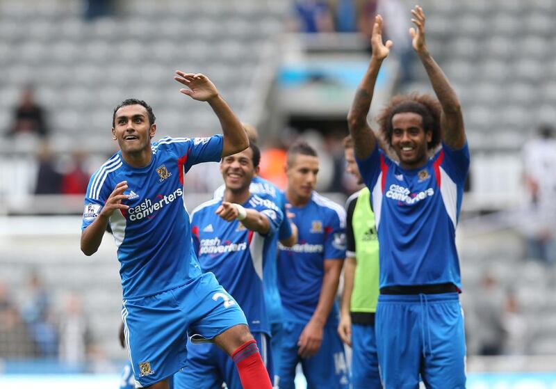 Egyptian midfielder Ahmed Elmohamady, left, celebrates with a dance while his Hull City teammates look on after a win at Newcastle United. Ian Macnicol / AFP

