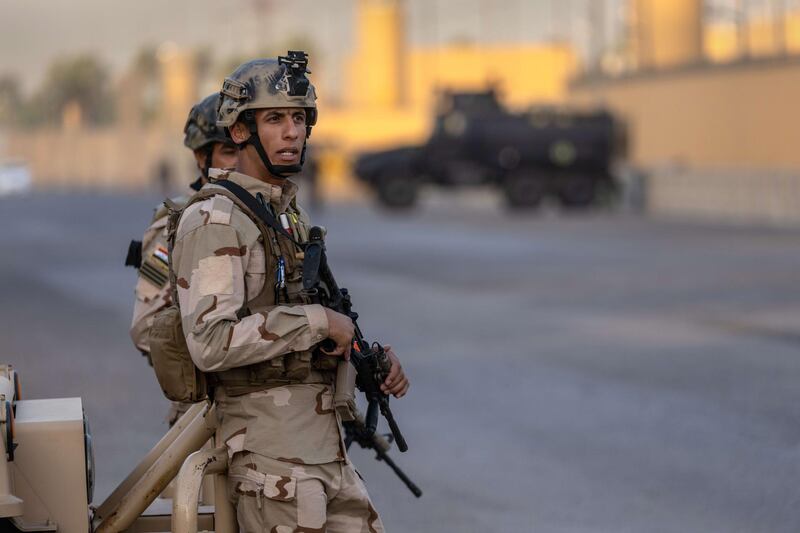 BAGHDAD, IRAQ - MAY 30: Iraqi Army soldiers stand guard on a road between the U.S. Embassy and the International Zone on May 30, 2021 in Baghdad, Iraq. Coalition forces based in Baghdad's International Zone are part of the U.S.-led Military Advisor Group of 13 nations supporting the Iraqi Security Forces. The United States currently maintains 2,500 military personnel in Iraq as part of Operation Inherent Resolve.   John Moore/Getty Images/AFP
== FOR NEWSPAPERS, INTERNET, TELCOS & TELEVISION USE ONLY ==
