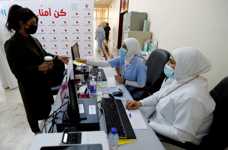 A woman takes her appointment for a second dose of a Covid-19 vaccine in Manama. Reuters