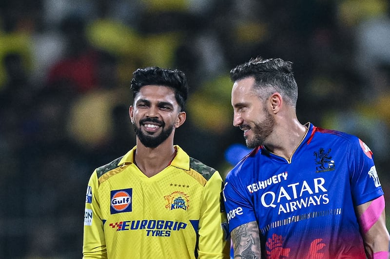 Chennai Super Kings' new captain Ruturaj Gaikwad talks with his Royal Challengers Bangalore counterpart Faf du Plessis during the toss. AFP