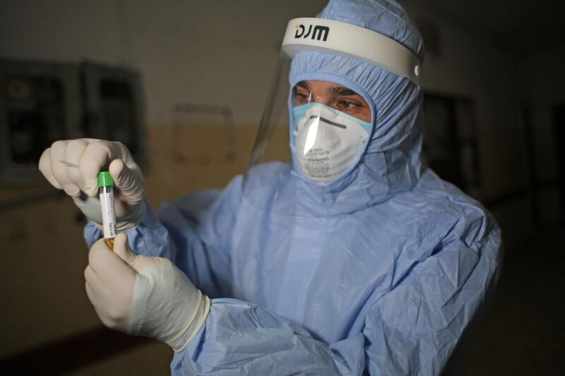 A Palestinian health worker collects a swab sample from a player of Shabab Rafah team in the southern Gaza Strip.  AFP