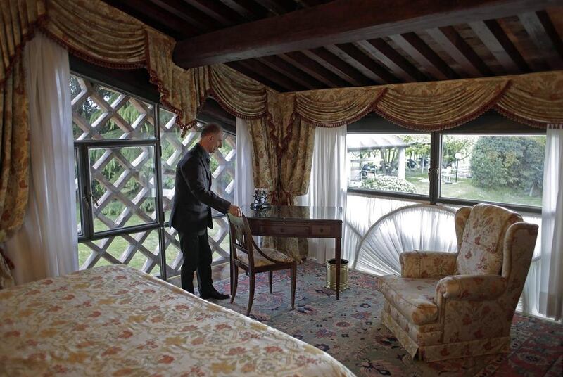 Maurizio Tagliavia sets the room for guests at Villa Del Quar. Max Rossi / Reuters