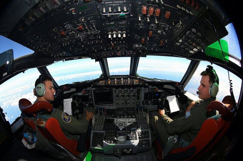Flight Lieutenants Russell Adams (L) and Joal McCutcheon sit in the cockpit of a Royal Australian Air Force. Australia has been a key player in the search for the missing Malaysian Airlines jet. Paul Kane / Reuters March 26