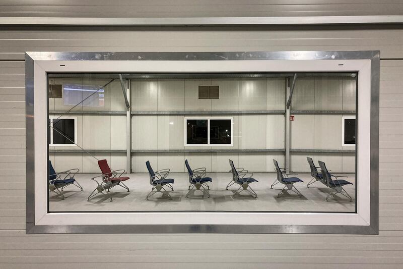 Empty seats at a boarding gate, seen through a window, at the airport in Nairobi, Kenya, December 23, 2020. AP