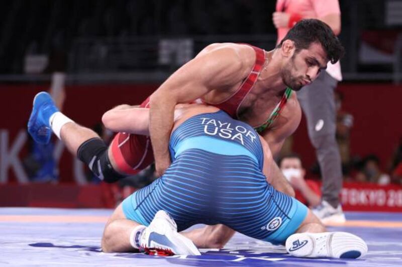 USA's David Taylor (blue) wrestles Iran's Hassan Yazdanicharati in their men's freestyle 86kg wrestling final, which Taylor won.