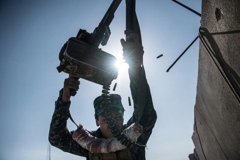 An Iraqi federal policeman fires a machine gun at an ISIL position on a nearby rooftop during fighting in west Mosul, Iraq. Iraqi forces backed by US and British air support have entered their sixth month of fighting as they continue the battle to retake the country’s second largest city from the extremists, who have held it since 2014. Carl Court / Getty Images / April 6, 2017