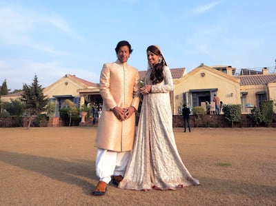 In this handout photograph released by the Pakistan Tehreek Insaf (PTI) party on January 8, 2015, Pakistani opposition leader Imran Khan (L) and new wife Reham Khan pose for a photograph during their wedding ceremony at his house in Islamabad. Pakistani opposition leader Imran Khan wed a TV journalist in a simple ceremony at his Islamabad home January 8, ending years of speculation surrounding the former playboy cricketer widely considered his country's most eligible man. AFP PHOTO/PAKISTAN TEHREEK INSAF (PTI) PARTY-----EDITORS NOTE---- RESTRICTED TO EDITORIAL USE MANDATORY CREDIT "AFP PHOTO/PAKISTAN TEHREEK INSAF (PTI) PARTY" NO MARKETING NO ADVERTISING CAMPAIGNS - DISTRIBUTED AS A SERVICE TO CLIENTS / AFP PHOTO / PTI / HO