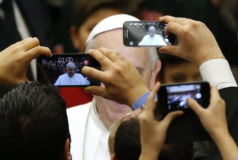 Pope Francis is pictured by mobile phones as he arrives to lead a special audience for Vatican employees and their families at the Paul VI’s hall at the Vatican. 

Alessandro Bianchi / Reuters