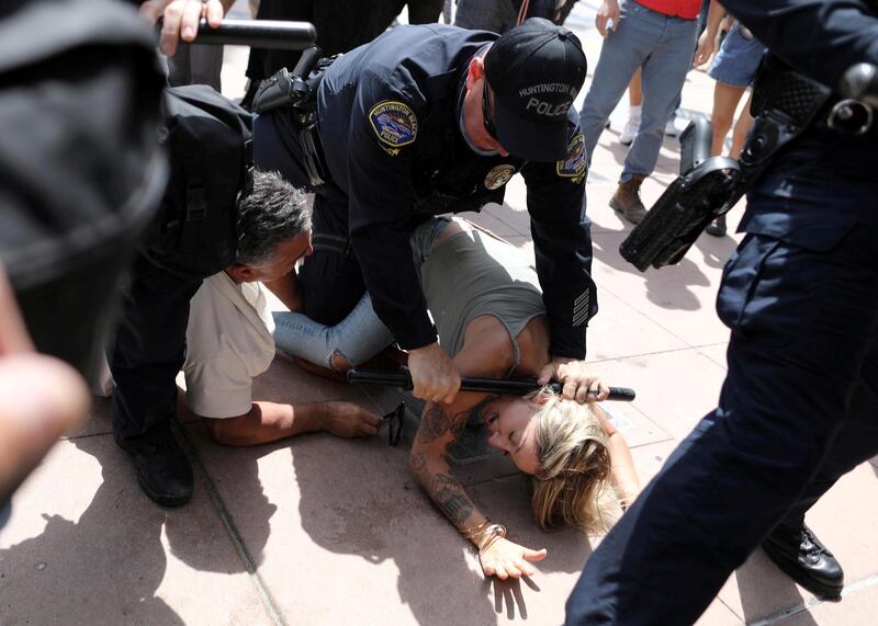 A police officer pins down a woman down during confrontations with protesters – including Black Lives Matter and White Lives Matter activists – in which at least six people were arrested, at Huntington Beach, California, US. Reuters