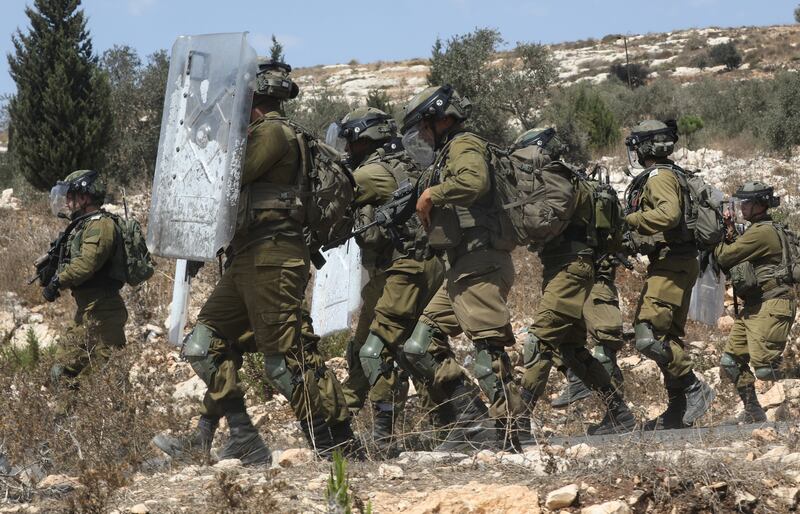 Israeli troops clash with Palestinian protesters after a demonstration against Israeli settlements in Kafr Qaddum, near the West Bank city of Nablus, on September 23. EPA