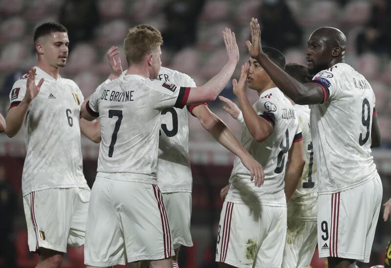 epa09094960 Romelu Lukaku of Belgium (R) celebrates with his team-mates after scoring the 3-1 goal  during the FIFA World Cup 2022 qualification match between Belgium and Wales in Leuven, Belgium, 24 March 2021.  EPA/STEPHANIE LECOCQ