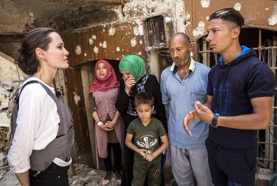 epa06812948 A handout photo made available by the United Nations High Commissioner for Refugees (UNHCR) shows UNHCR Special Envoy Angelina Jolie (L) meets with Mohamed and his family during a visit to the Old City in West Mosul, Iraq, 16 June 2018. During the offensive to retake the city from ISIS Mohamed’s house was hit by an airstrike killing his 17 year-old daughter and destroying most of the home. Together with his three surviving children and his wife, Mohamed fled to the home of a family friend, where they have been living ever since. However the host family can no longer support them and Mohamed may have to bring his family back to live in the ruins of their home.  EPA/Andrew McConnell / HANDOUT  HANDOUT EDITORIAL USE ONLY/NO SALES