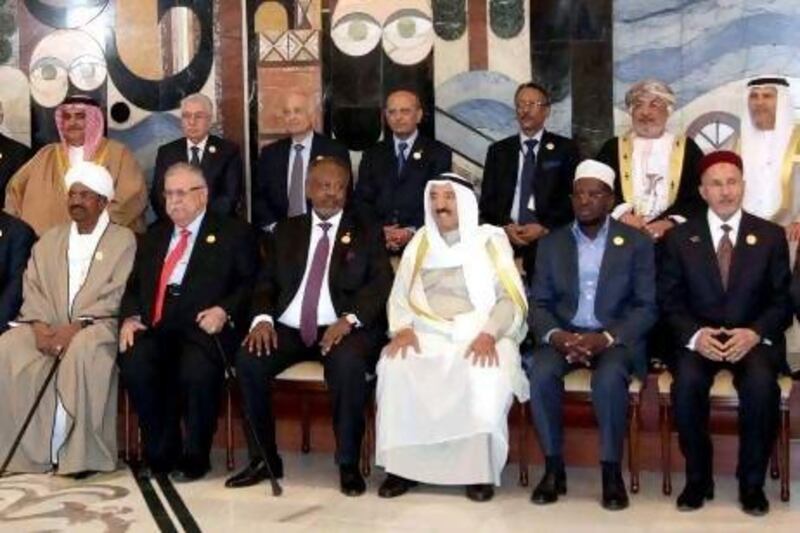 Leaders at the Arab Summit in Iraq pose for a group photo before the start of formal meetings. Front row, left to right, Sudanese President Omar Al Bashir, Iraqi President Jalal Talabani, Djibouti's President Ismail Omar Guelleh, Kuwait's emir Sheikh Sabah Al Ahmad Al Sabah, Somalia's President Sheik Sharif Sheik Ahmed and Chairman of Libyan National Transitional Council Mustafa Abdul Jalil.