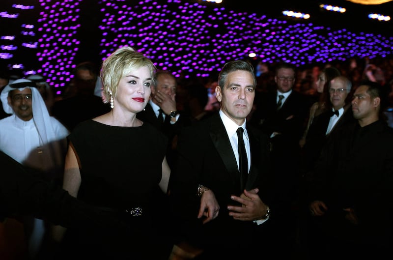 US actress Sharon Stone arrives with actor and director George Clooney at the opening of the 4th Dubai International Film Festival in 2007. AFP 