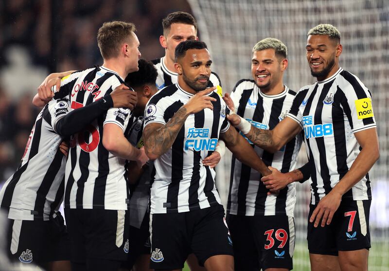 Newcastle's Callum Wilson celebrates with teammates after scoring. PA