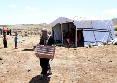 Internally displaced woman from Deraa walks outside a tent near the Israeli-occupied Golan Heights, in Quneitra, Syria June 21, 2018. REUTERS/Alaa al-Faqir